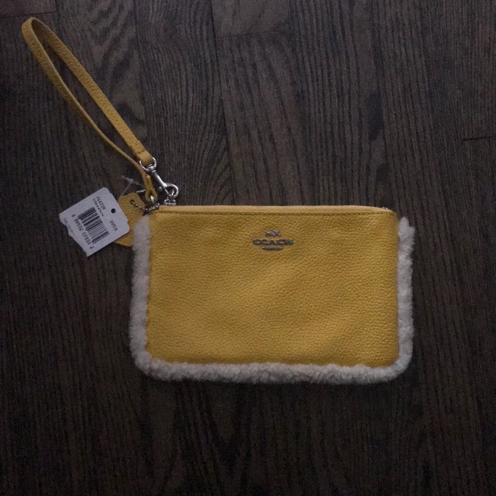 Yellow and fuzzy coach wristlet